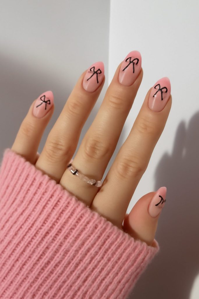 3. short almond shaped light pink french tip nail designs with cute bow and rhinestone nail art